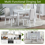 White rectangular dining table with upholstered chairs