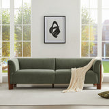 Contemporary olive green upholstered sofa featuring premium velvet fabric and teak wood accents