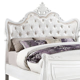 White carved wooden king size bed with tufted headboard