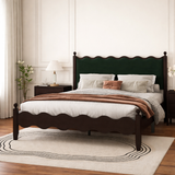 Wooden wave-design bed with green upholstered headboard