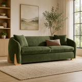 Modern green velvet sofa with solid teak wood base