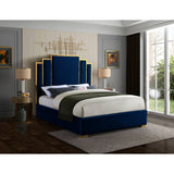 Modern teak wood bed with geometric wingback headboard in blue velvet.