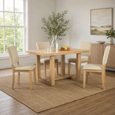 Solid teak wood dining table set with upholstered chairs in modern farmhouse dining room