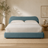 Luxury teal upholstered bed with teak wood frame