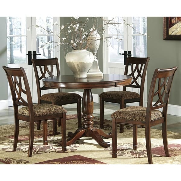 Elegant brown dining chairs with patterned upholstery