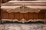 Hand carved tufted upholstered headboard with ornate gold carving
