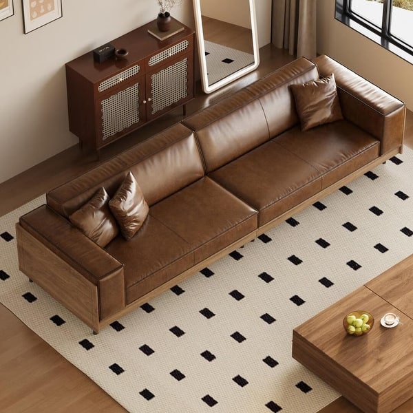 Elegant teak wood sofa with brown leather cushions

