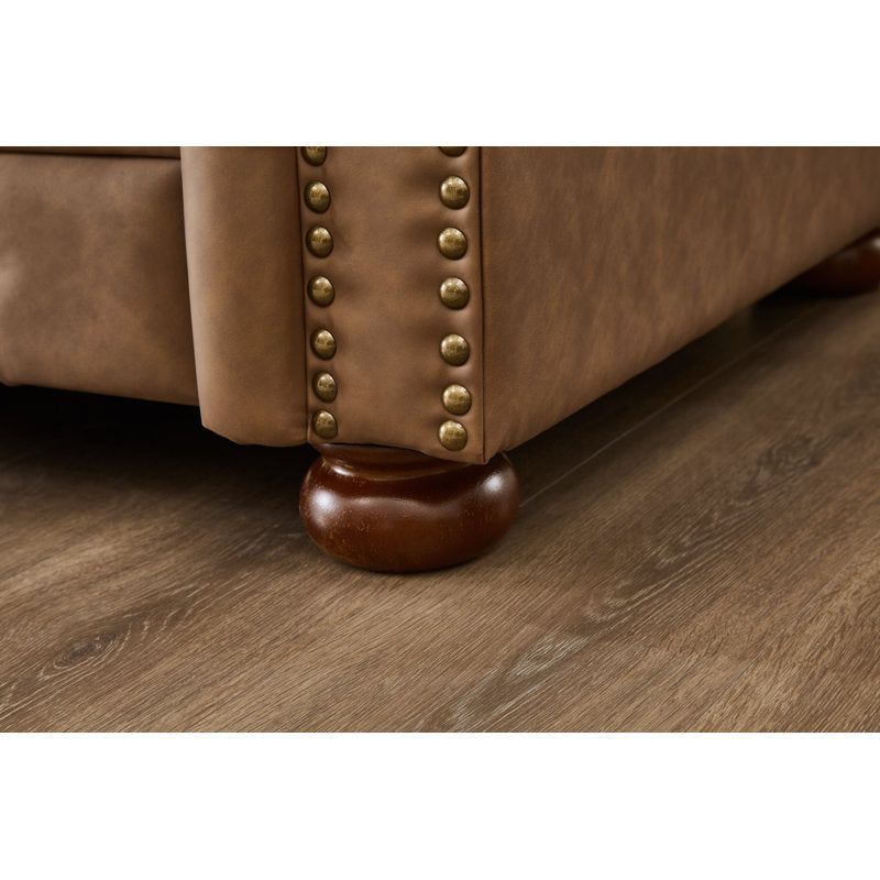 Elegant brown Chesterfield sofa with rolled arm design
