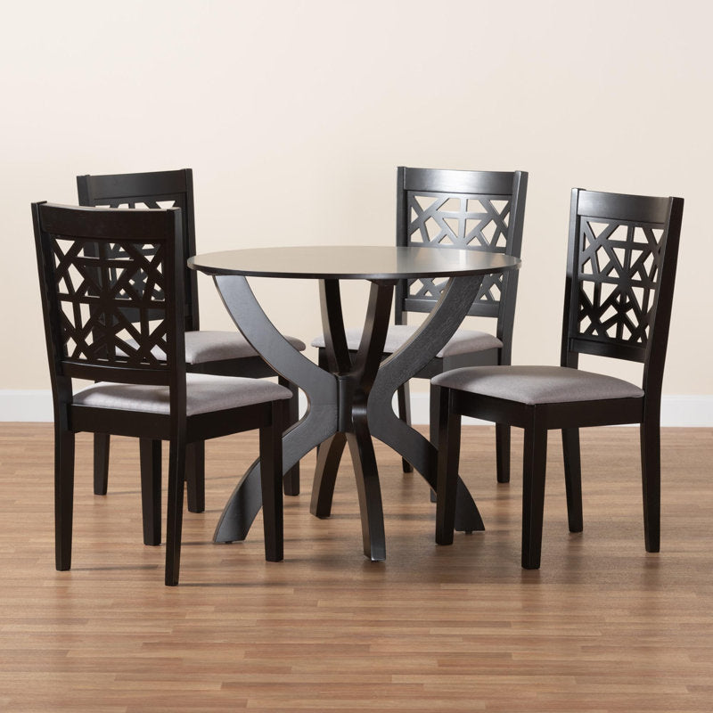 Contemporary black round dining table with geometric back chairs