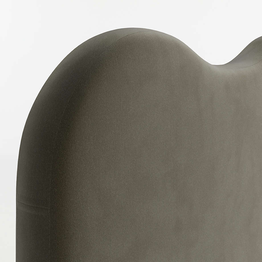 Modern upholstered bed featuring sculpted headboard