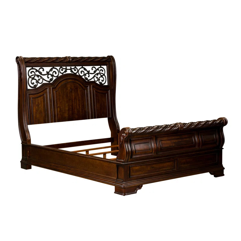 Elegant sleigh bed with decorative wood carving