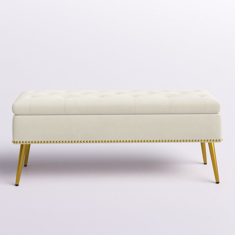 Cream fabric bench with gold metal legs
