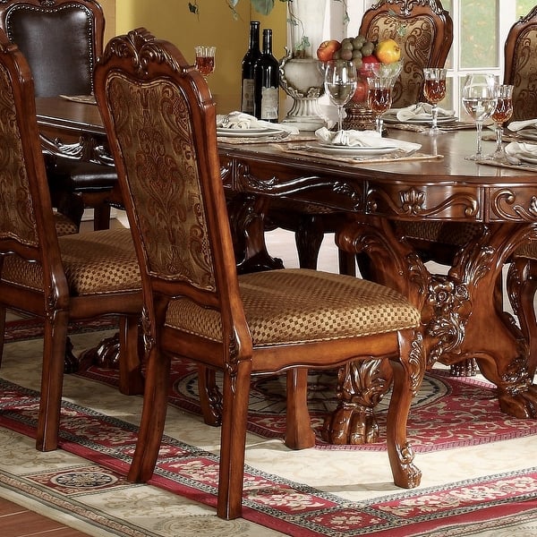 Royal carved wooden dining table with upholstered chairs