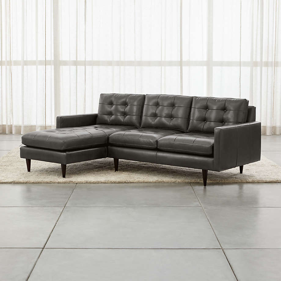 Modern tufted sectional sofa with teak wood frame and chaise seating.