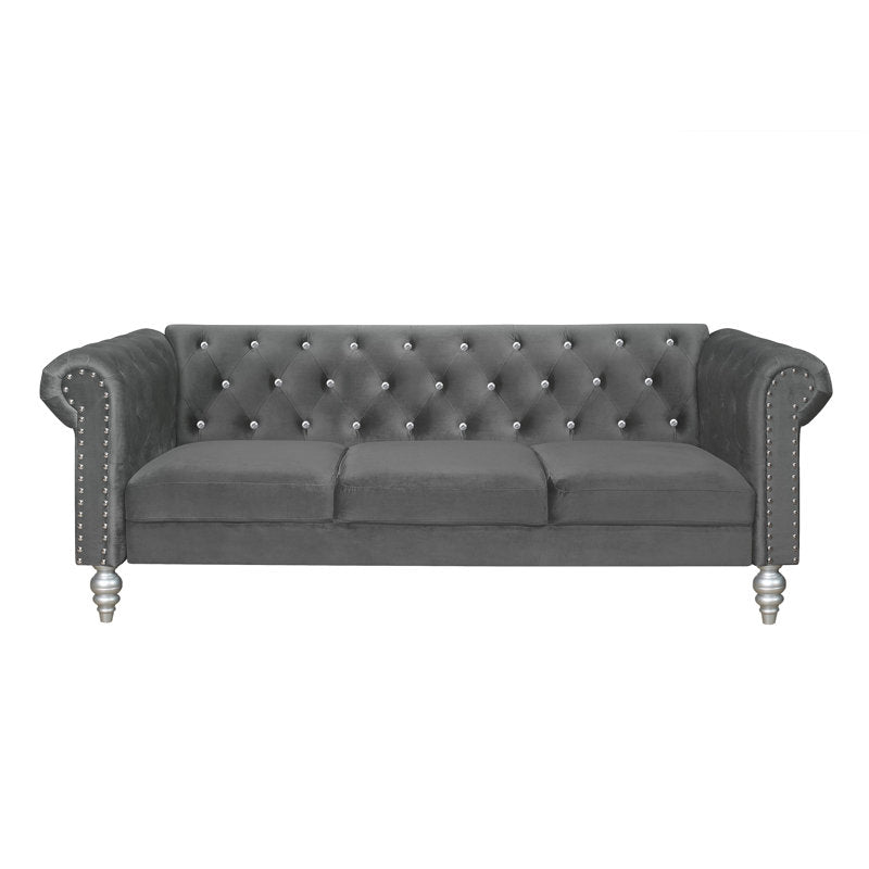 Elegant tufted velvet sofa featuring solid teak wood frame and rolled arms