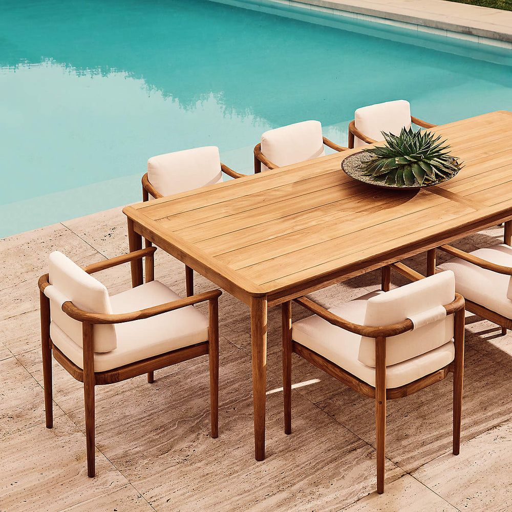 Luxury wooden dining table with cushioned chairs