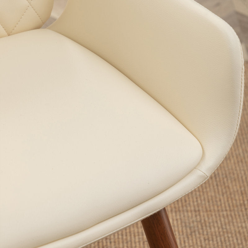 Contemporary round dining table with cream chairs