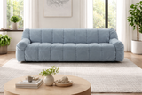 Modern blue tufted sofa in minimalist living room