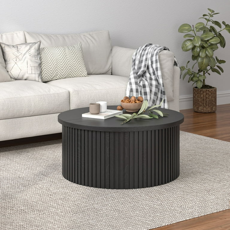Elegant matte black round coffee table with decorative top styling