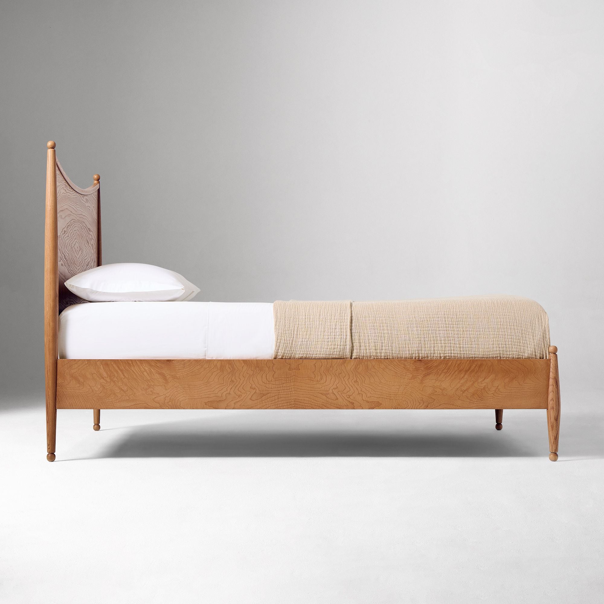 Solid teak wood bed with warm natural grain details