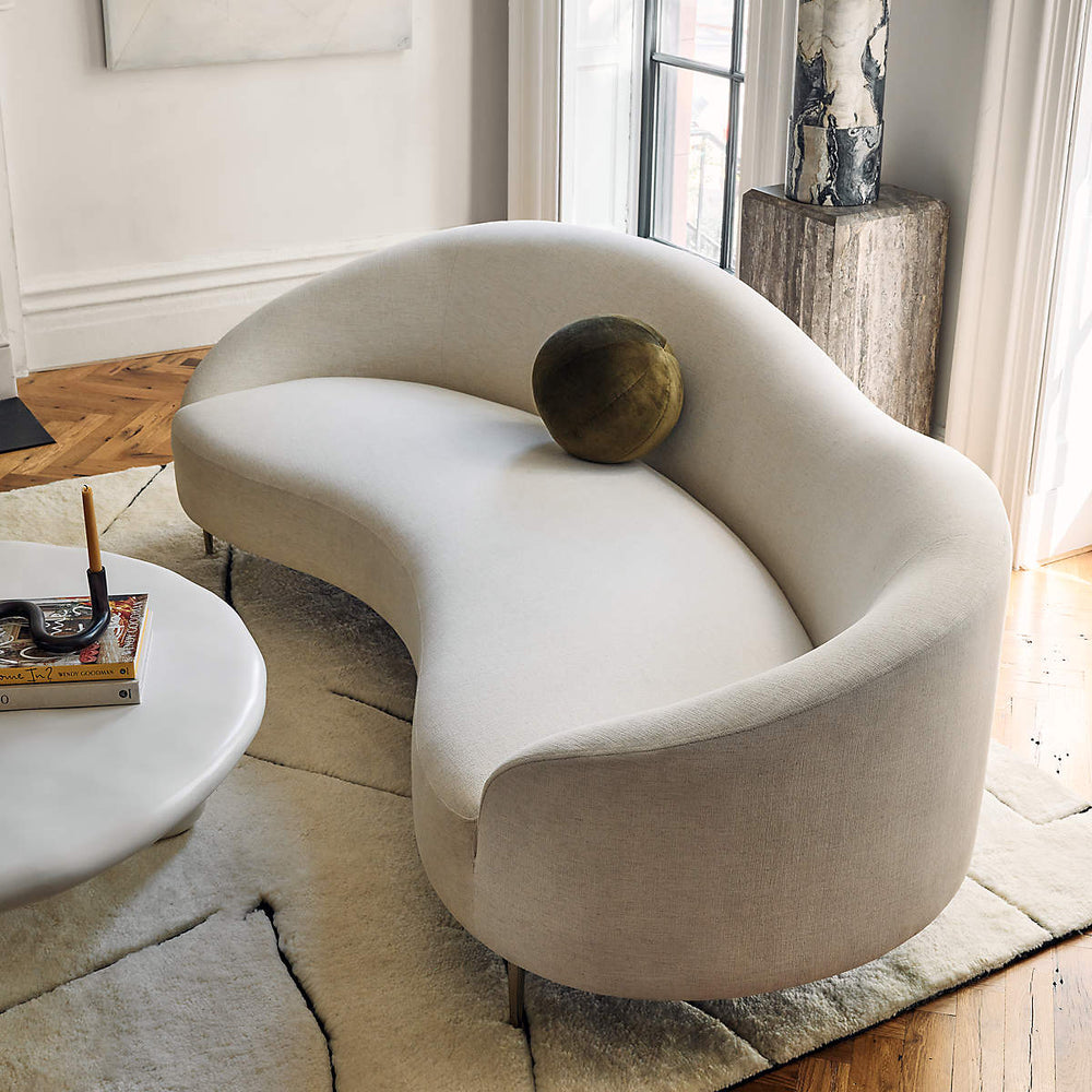 Contemporary cream fabric sofa with curved backrest