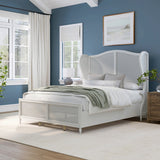 white wooden bed with woven headboard