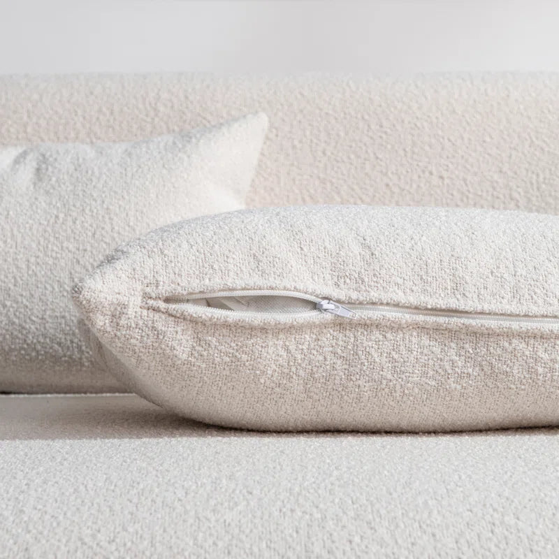modern off white sofa with bolster pillows
