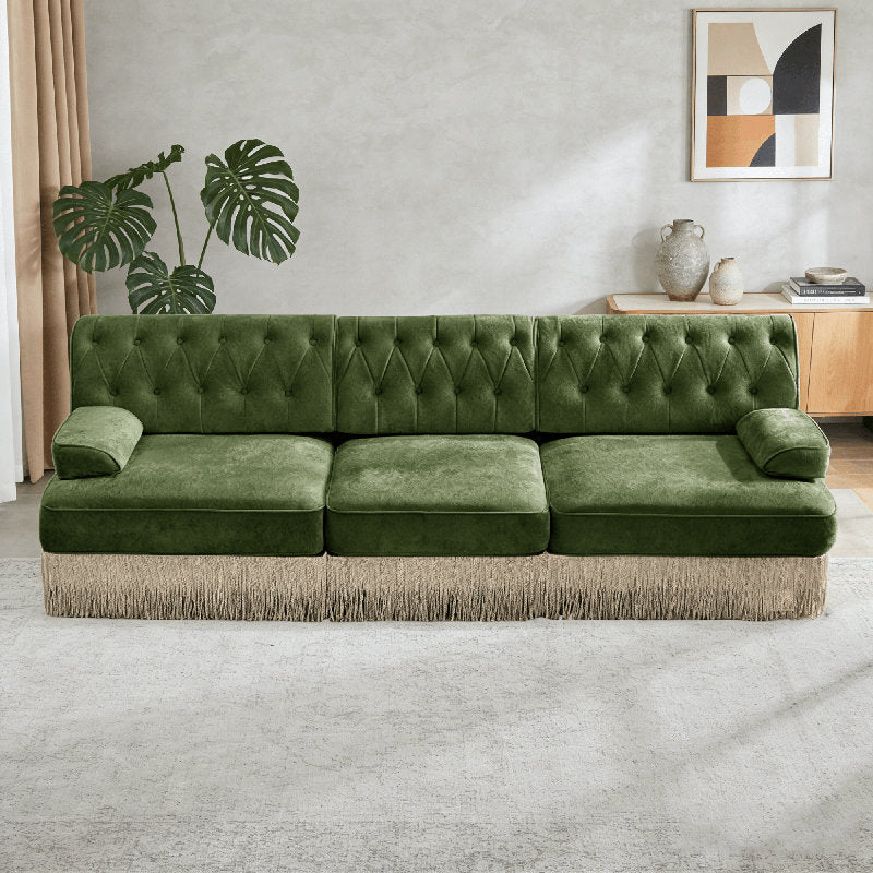 Olive green button tufted sofa with decorative fringe