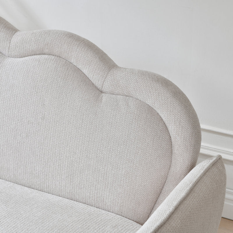 Cream fabric sofa with scalloped backrest