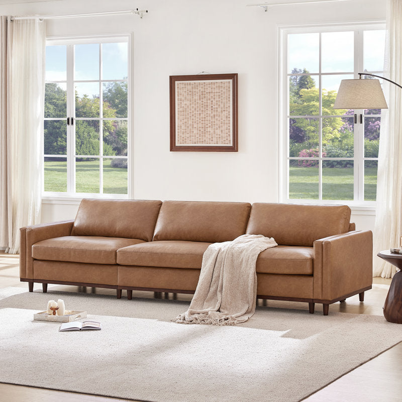 Elegant brown leather sofa with solid teak wood frame