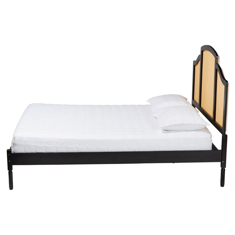 black wooden bed with woven cane headboard