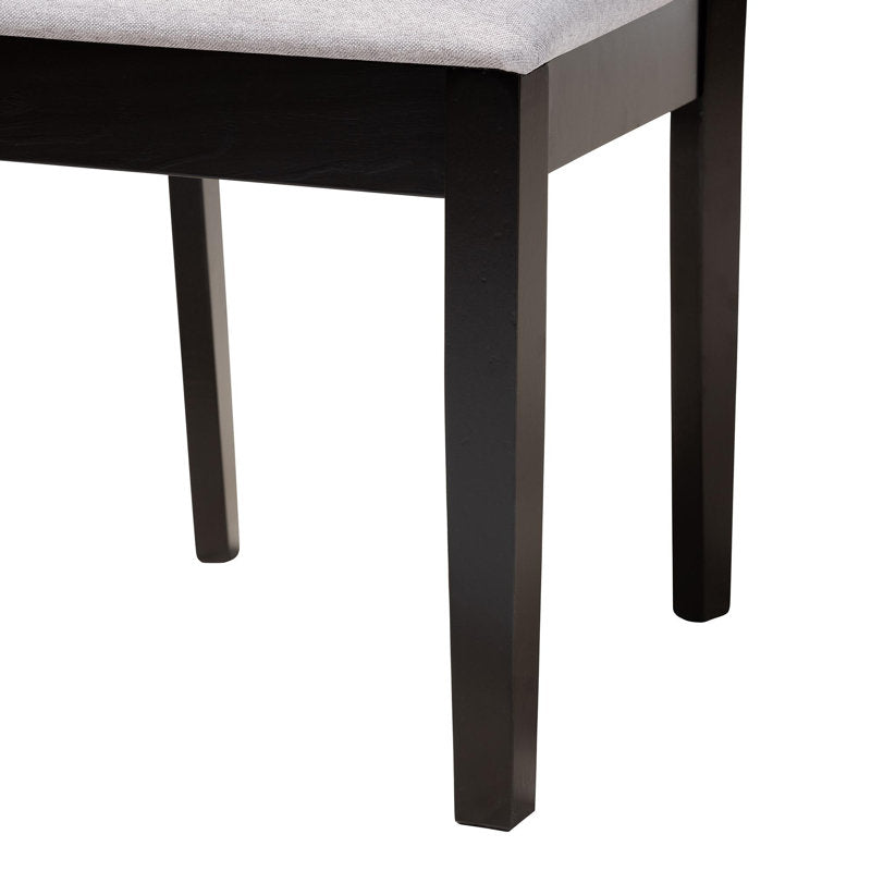 Black pedestal dining table with upholstered seating set