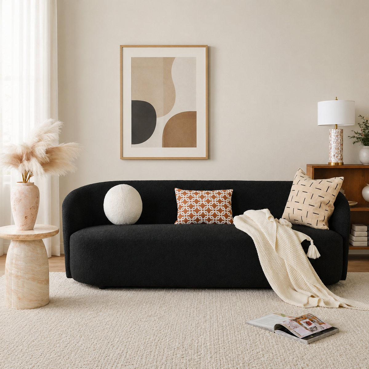Curved black bouclé sofa with solid teak wood frame in modern living room