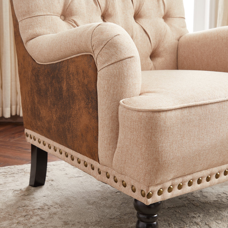 Beige button tufted accent chairs with teak wood legs and armrests