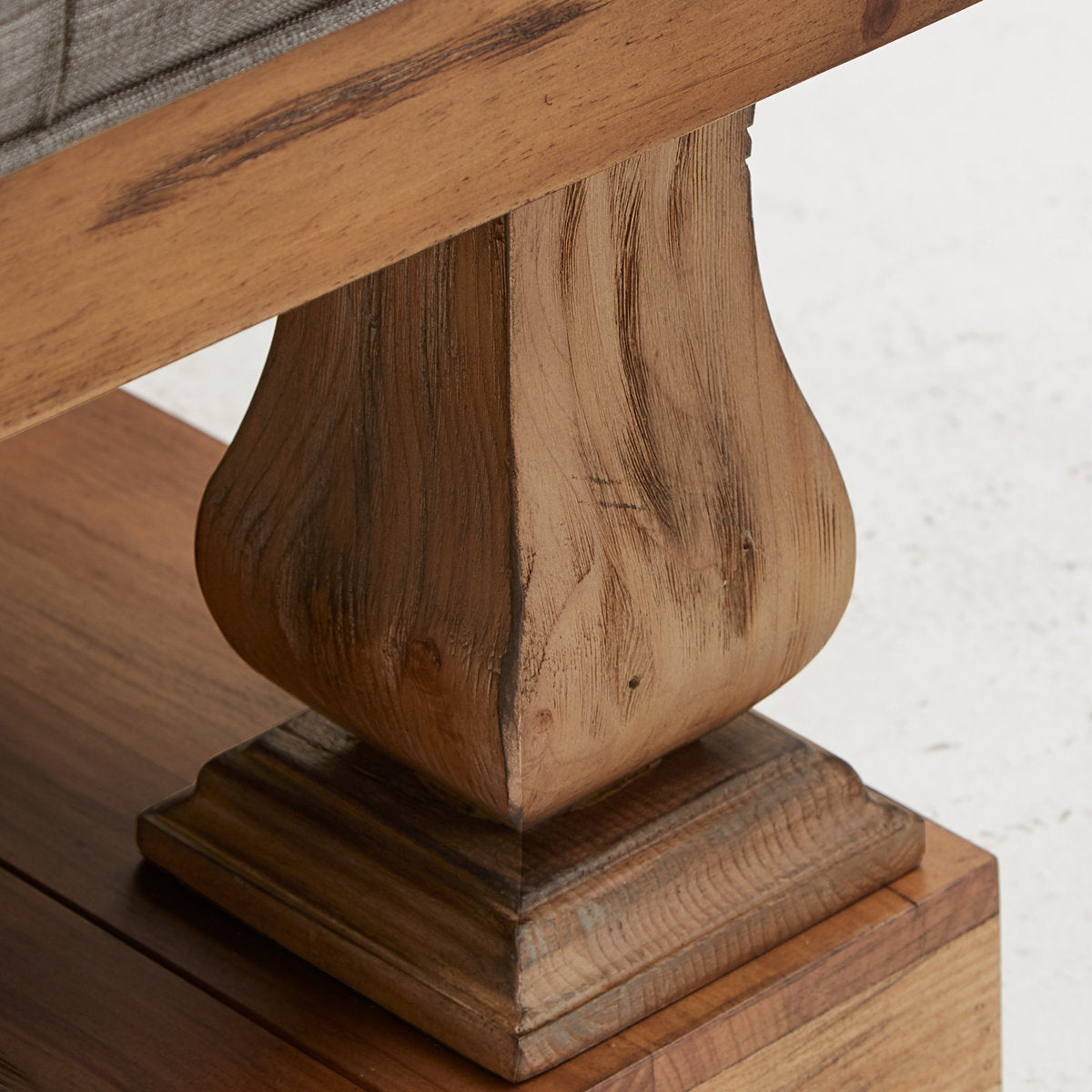 Rustic teak wood center table with cushioned tufted upholstery