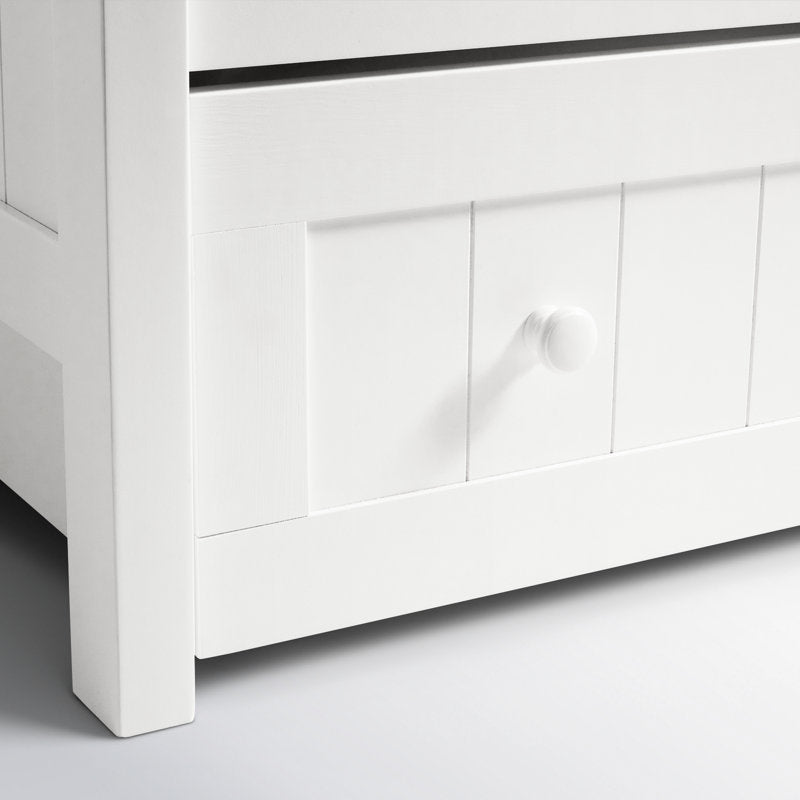 White wooden daybed with pull-out storage.
