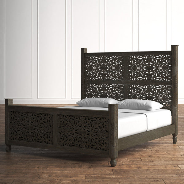 ​Bohemian style carved wood bed in brick wall bedroom.