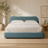 Luxury teal upholstered bed with teak wood frame