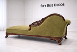 Antique style Victorian chaise lounge sofa with luxury upholstery and carved wooden frame
