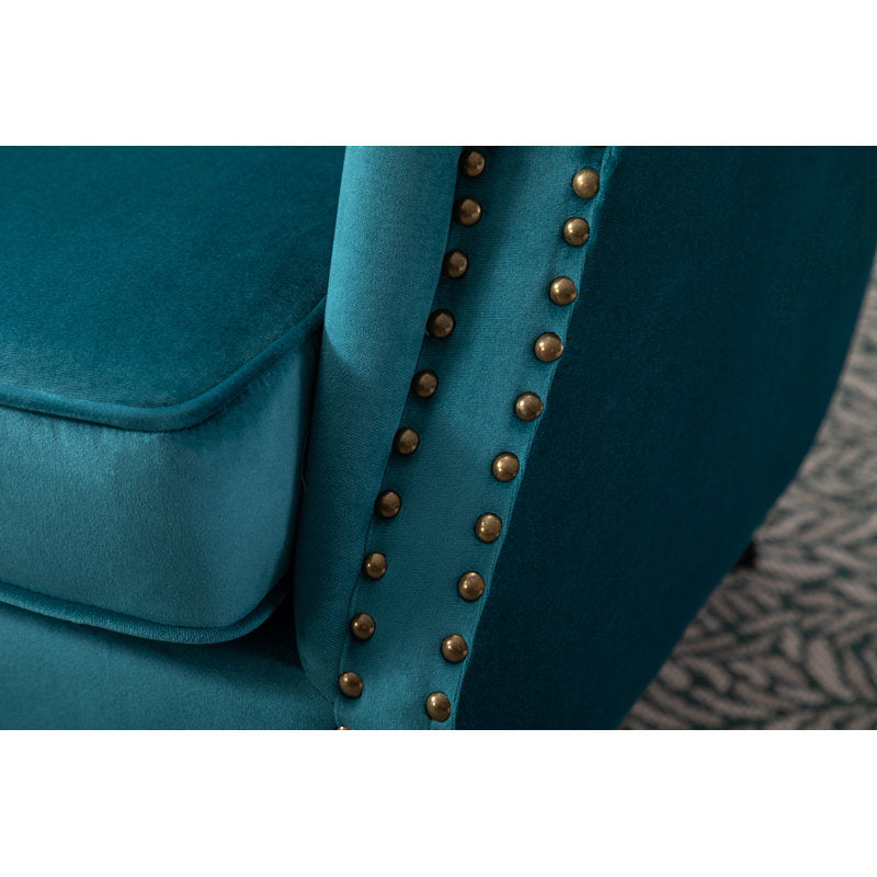 Velvet upholstered lounge chair with decorative stud accents