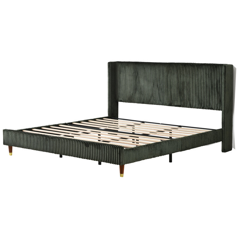 designer bedroom bed with green upholstered headboard
