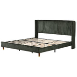 designer bedroom bed with green upholstered headboard
