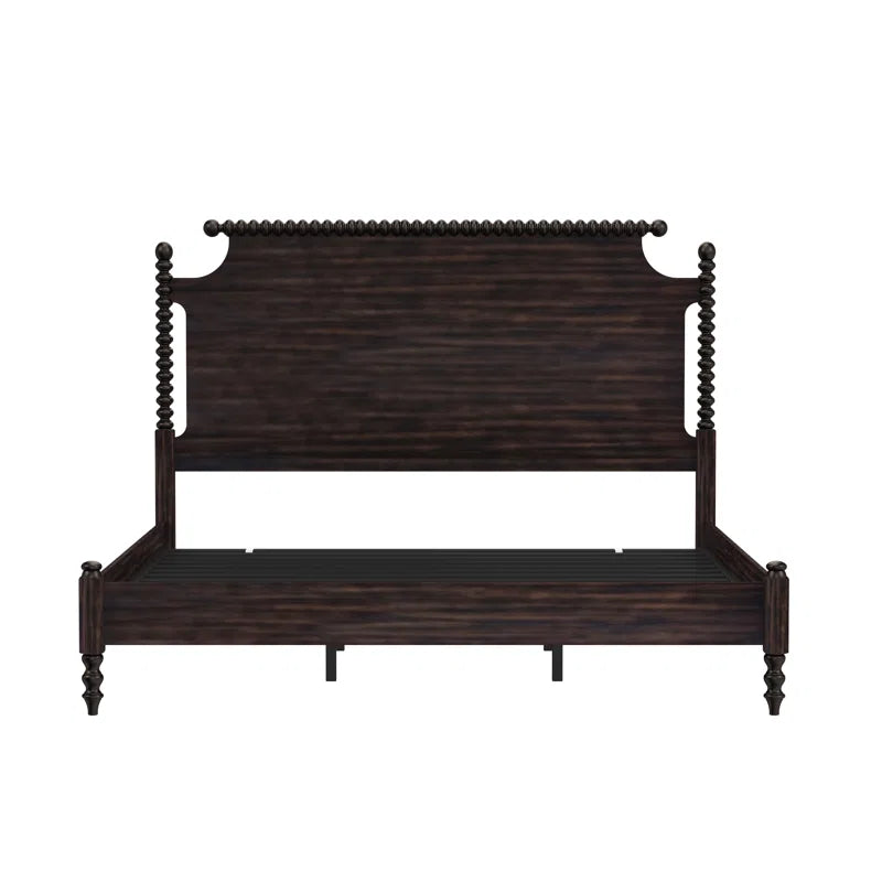 ​Traditional dark wood spindle bed with pink medallion area rug